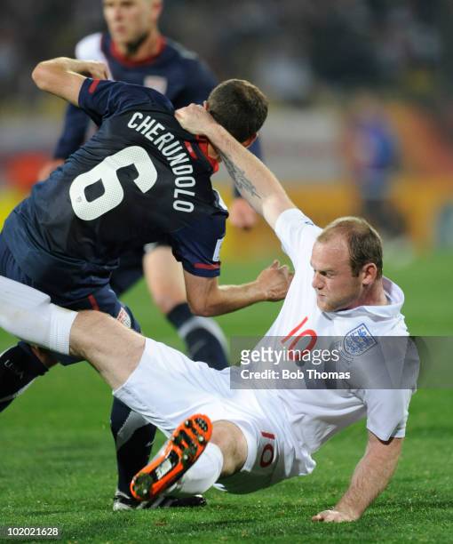 Wayne Rooney of England grabs hold of Steve Cherundolo of the USA during the 2010 FIFA World Cup South Africa Group C match between England and USA...
