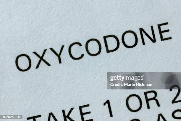 close-up of a section of a pharmaceutical label of the drug oxycodone on a pill bottle. - oxycontin stock pictures, royalty-free photos & images