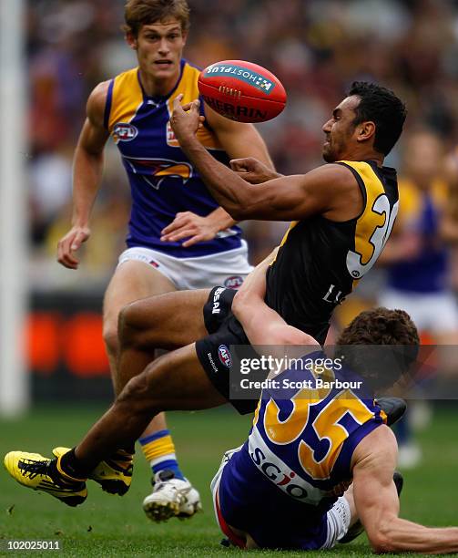 Richard Tambling of the Tigers is tackled during the round 12 AFL match between the Richmond Tigers and the West Coast Eagles at Melbourne Cricket...