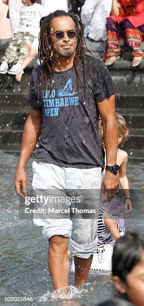 Tennis great Yannick Noah is seen sitting at the fountain in Washington Square Park on June 12, 2010 in New York, New York.