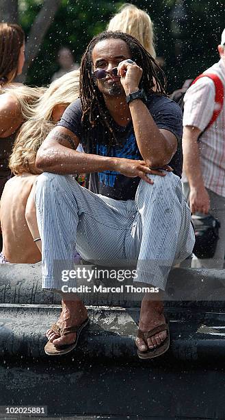 Tennis great Yannick Noah is seen sitting at the fountain in Washington Square Park on June 12, 2010 in New York, New York.