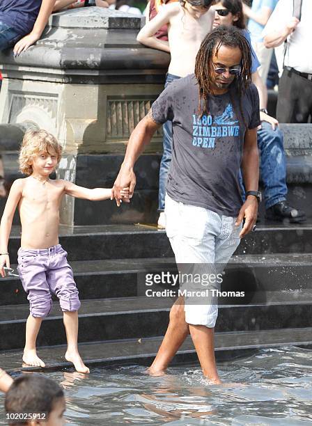 Tennis great Yannick Noah and son Joalukas Noah are seen at the fountain in Washington Square Park on June 12, 2010 in New York, New York.