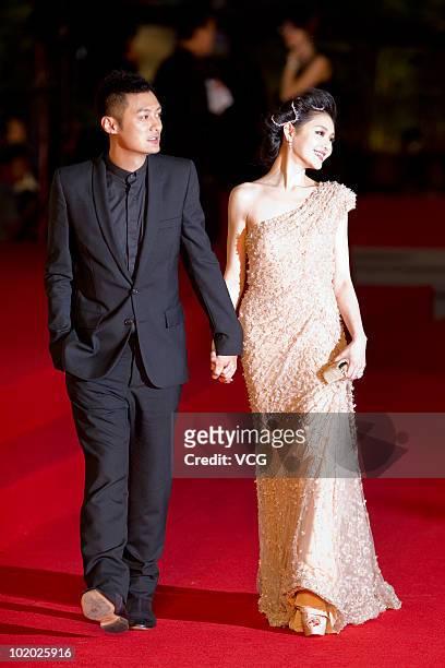 Hong Kong actor Shawn Yue and Taiwanese actress Barbie Hsu pose on the red carpet during the 13th Shanghai Film Festival on June 12, 2010 in Shanghai...