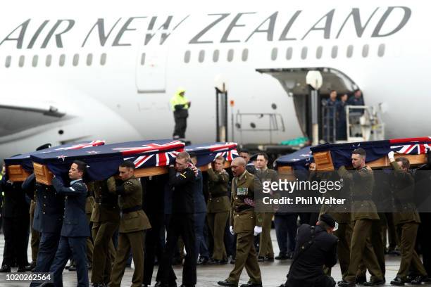 The remains of New Zealand Defence Force personnel repatriated from Malaysia and Singapore arrive at Auckland International Airport on August 21,...