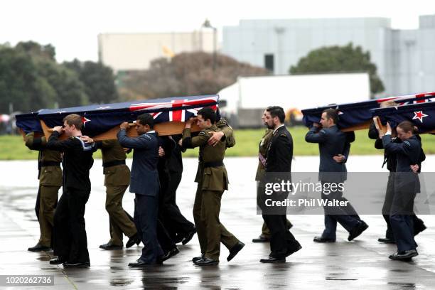 The remains of New Zealand Defence Force personnel repatriated from Malaysia and Singapore arrive at Auckland International Airport on August 21,...