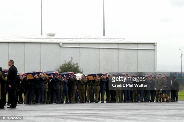 The remains of New Zealand Defence Force personnel repatriated from Malaysia and Singapore arrive at Auckland International Airport on August 21,...