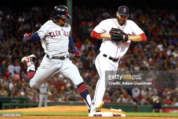 Francisco Lindor of the Cleveland Indians is safe at first base ahead of Rick Porcello of the Boston Red Sox in the sixth inning of a game at Fenway...