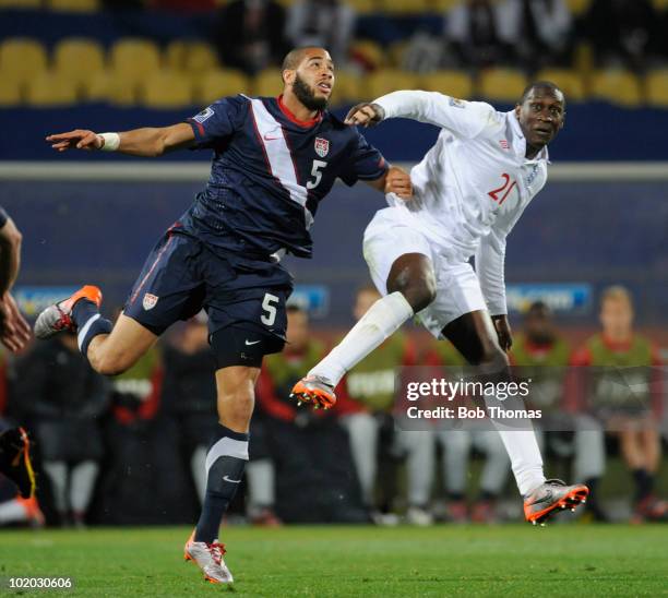 Emile Hesky of England clashes with Oguchi Onyewu of the USA during the 2010 FIFA World Cup South Africa Group C match between England and USA at the...