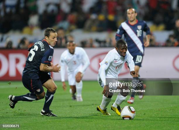 Shaun Wright-Phillips of England moves away with the ball while watched by Steve Cherundolo of the USA during the 2010 FIFA World Cup South Africa...