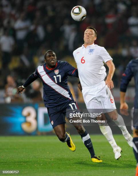 John Terry of England controls the ball while watched by Jozy Altidore of the USA during the 2010 FIFA World Cup South Africa Group C match between...