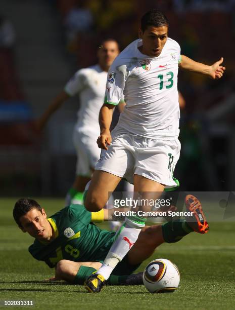 Karim Matmour of Algeria evades a challenge by Robert Koren of Slovenia during the 2010 FIFA World Cup South Africa Group C match between Algeria and...