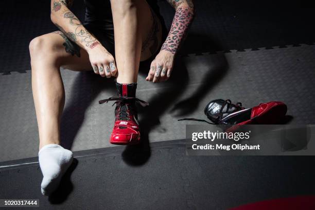 Australian UFC veteran and bare knuckle fighter Bec Rawlings puts on her shoes at City of Angels Boxing Club on August 16, 2018 in Los Angeles,...