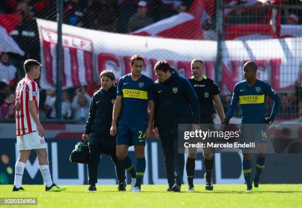 Carlos Izquierdoz of Boca Juniors leaves the field after being injured during a match between Estudiantes and Boca Juniors as part of Superliga...