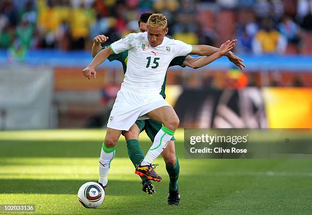 Karim Ziani of Algeria holds off Andraz Kirm of Slovenia during the 2010 FIFA World Cup South Africa Group C match between Algeria and Slovenia at...