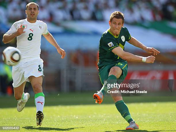 Valter Birsa of Slovenia shoots as Medhi Lacen looks on during the 2010 FIFA World Cup South Africa Group C match between Algeria and Slovenia at the...