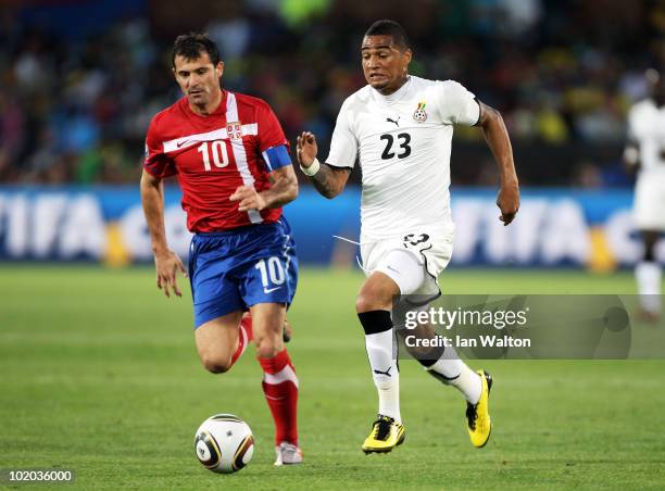 Kevin Prince Boateng of Ghana chases the ball with Dejan Stankovic of Serbia during the 2010 FIFA World Cup South Africa Group D match between Serbia...