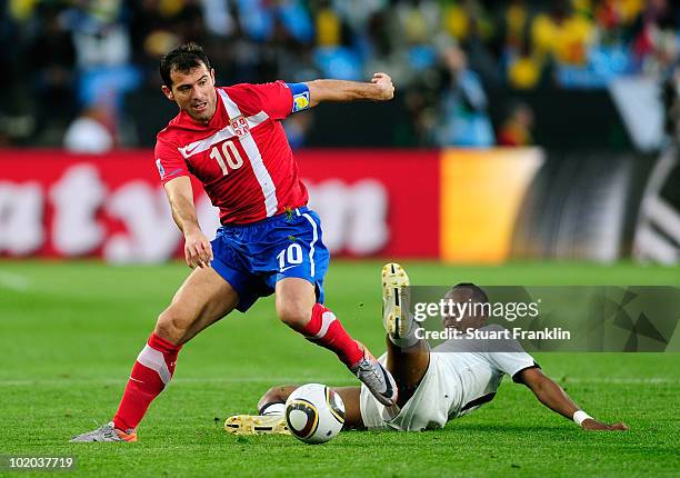 Dejan Stankovic of Serbia rides the tackle by Andrew Ayew of Ghana during the 2010 FIFA World Cup South Africa Group D match between Serbia and Ghana...