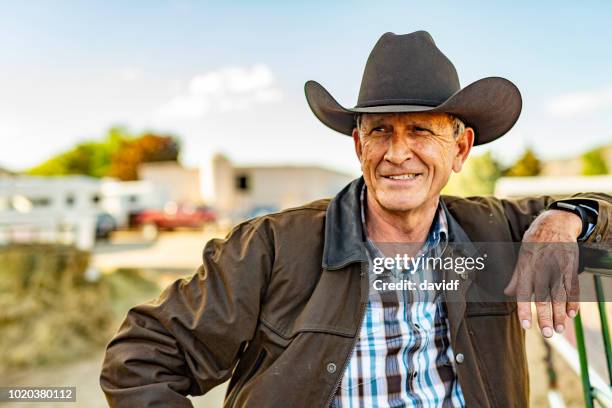 portrait of a senior cowboy on a horse ranch - rancher stock pictures, royalty-free photos & images