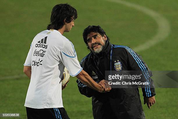 Argentina's head coach Diego Maradona talks with Javier Pastore during a team training session on June 13, 2010 in Pretoria, South Africa.
