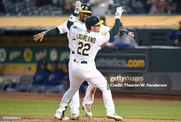 Ramon Laureano and Marcus Semien of the Oakland Athletics celebrates after Laureano hit a two-run home run against the Texas Rangers in the bottom of...