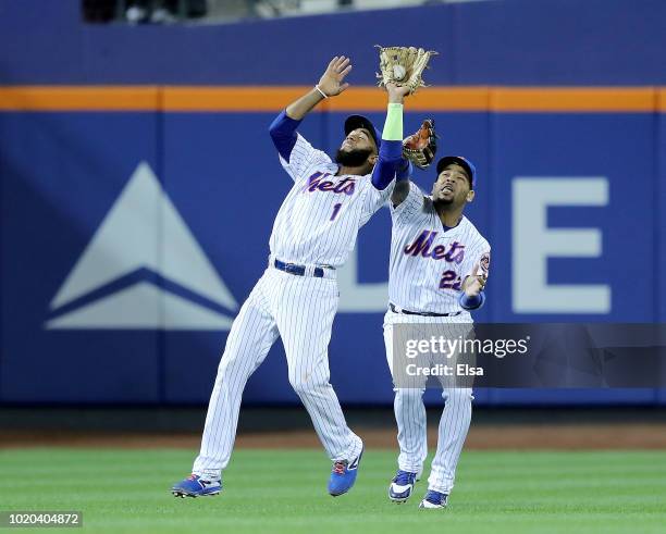 Dominic Smith and Amed Rosario of the New York Mets collide on a hit by Brandon Crawford of the San Francisco Giants in the 13th innning scoring...