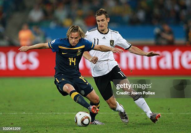 Brett Holman of Australia is closed down by Miroslav Klose of Germany during the 2010 FIFA World Cup South Africa Group D match between Germany and...