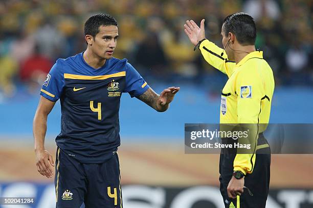 Referee Marco Rodriguez asks Tim Cahill of Australia to leave the pitch after showing a straight red card following a tackle on Bastian...