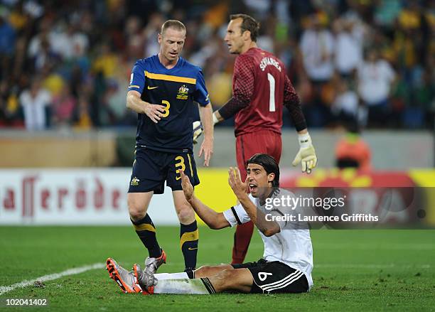 Sami Khedira of Germany complains after being tackled by Craig Moore of Australia during the 2010 FIFA World Cup South Africa Group D match between...