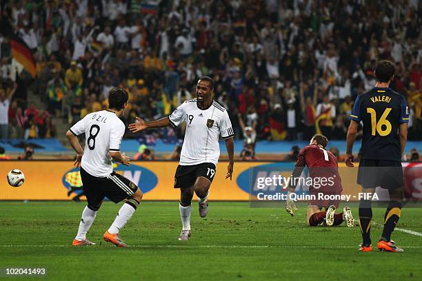 Cacau of Germany celebrates with team mate Mesut Oezil scoring his side's fourth goal while goalkeeper Mark Schwarzer of Australia can just watch on...