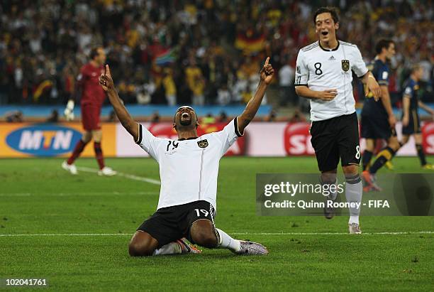 Cacau of Germany celebrates scoring his side's fourth goal with team mate Mesut Oezil during the 2010 FIFA World Cup South Africa Group D match...