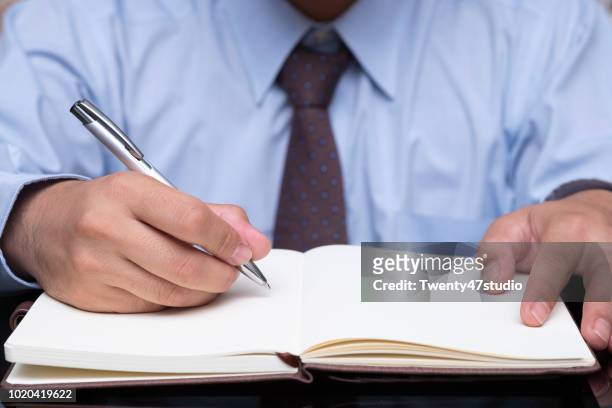 man hand with pen writing on notebook - hand written letter ストックフォトと画像