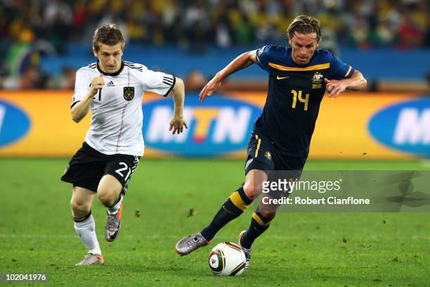 Marko Marin of Germany pursues Brett Holman of Australia during the 2010 FIFA World Cup South Africa Group D match between Germany and Australia at...