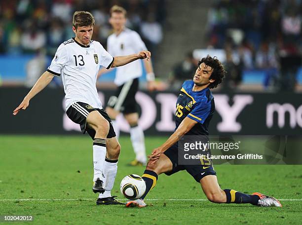 Thomas Mueller of Germany clashes with Mile Jedinak of Australia during the 2010 FIFA World Cup South Africa Group D match between Germany and...