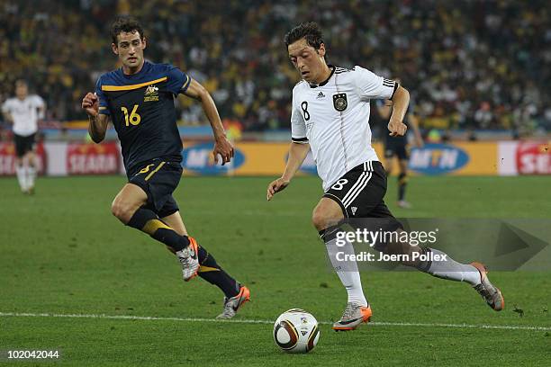 Mesut Oezil of Germany is closed down by Carl Valeri of Australia during the 2010 FIFA World Cup South Africa Group D match between Germany and...