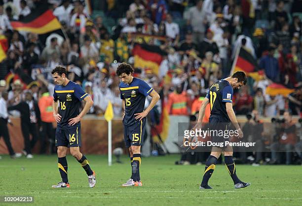 Mile Jedinak Carl Valeri and Nikita Rukavytsya of Australia look dejected after losing to Germany during the 2010 FIFA World Cup South Africa Group D...