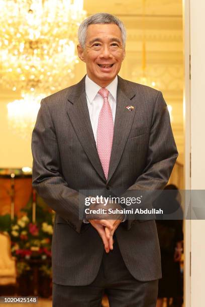 Singapore Prime Minister, Lee Hsien Loong waits to receive Myanmar State Counsellor Aung San Suu Kyi at the Istana on August 21, 2018 in Singapore....