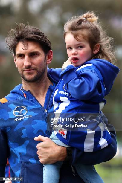 Jarrad Waite of the North Melbourne Kangaroos is seen with his daughter during a press conference at Arden Street Ground on August 21, 2018 in...