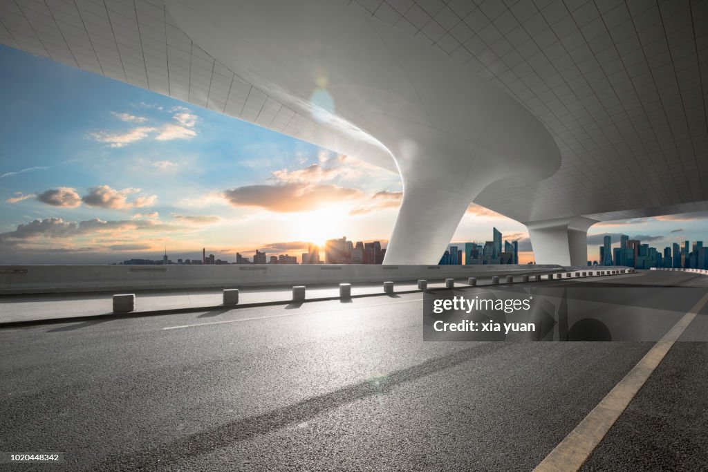 Empty road with city skyline