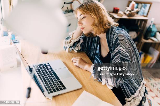 young woman working at home - tired foto e immagini stock