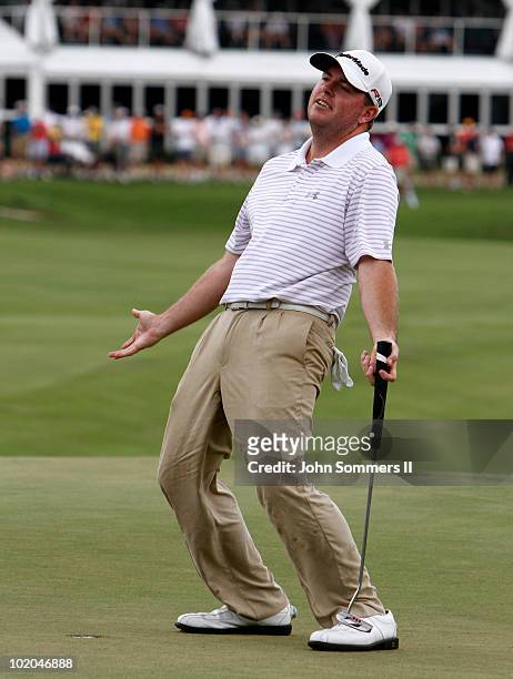 Robert Garrigus of the United States reacts after making his putt on the 18th green to make it into a three way playoff with Robert Karlsson and Lee...