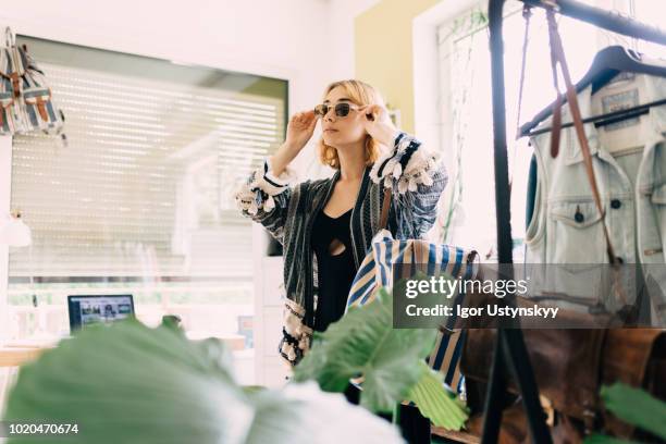 young woman getting ready to go out - trying on stock-fotos und bilder