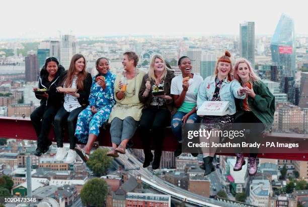 Winners of a competition enjoy a meal 450ft up on the roof of a central London skyscraper, as Deliveroo recreates 'Lunch Atop a Skyscraper', the...