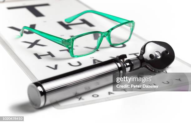 opthalmoscope and glasses on sight test chart - eyesight stock pictures, royalty-free photos & images