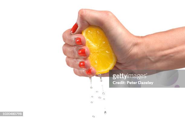 woman squeezing lemon against white background - lemon juice bildbanksfoton och bilder