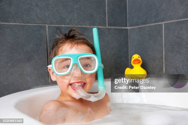 boy wearing snorkel have fun at bathtime - rubber duck stock pictures, royalty-free photos & images