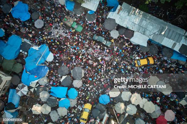 This aerial view showspedestrians and vehicles flowing through The Central Market, in Bamako on August 20 on the eve of the Islamic Festival of Eid...