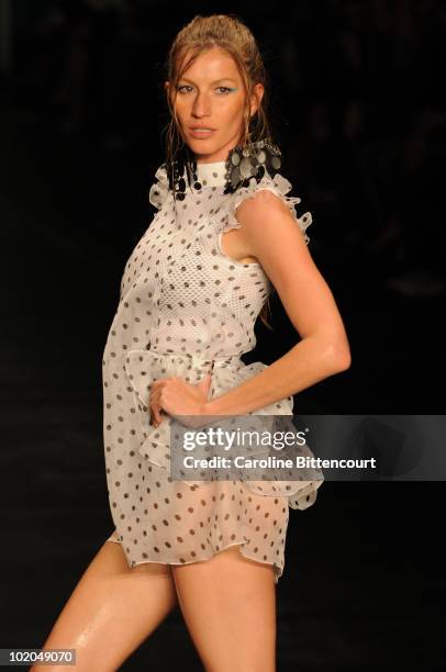 Model Gisele Bundchen displays a design by Colcci during the fifth day of the Sao Paulo Fashion Week Summer 2011 at the Ibirapuera's Bienal pavillion...