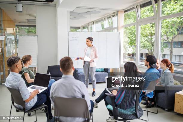 businesswoman giving presentation to team - digital marketing stock pictures, royalty-free photos & images