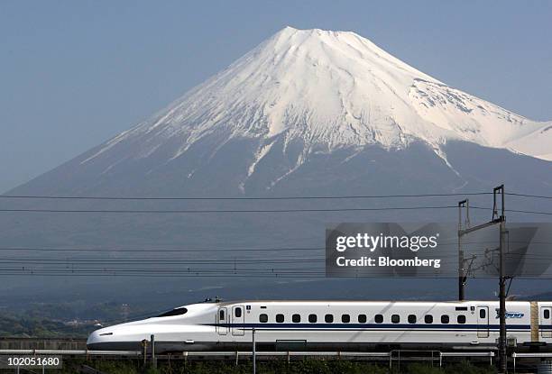 Central Japan Railway Co.'s N700 series Shinkansen bullet train travels past Mount Fuji, in Fuji City, Shizuoka Prefecture, Japan, on Friday, April...