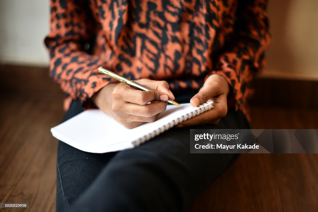 Girl writing on Notepad